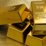 four pieces of gold bars on a golden background